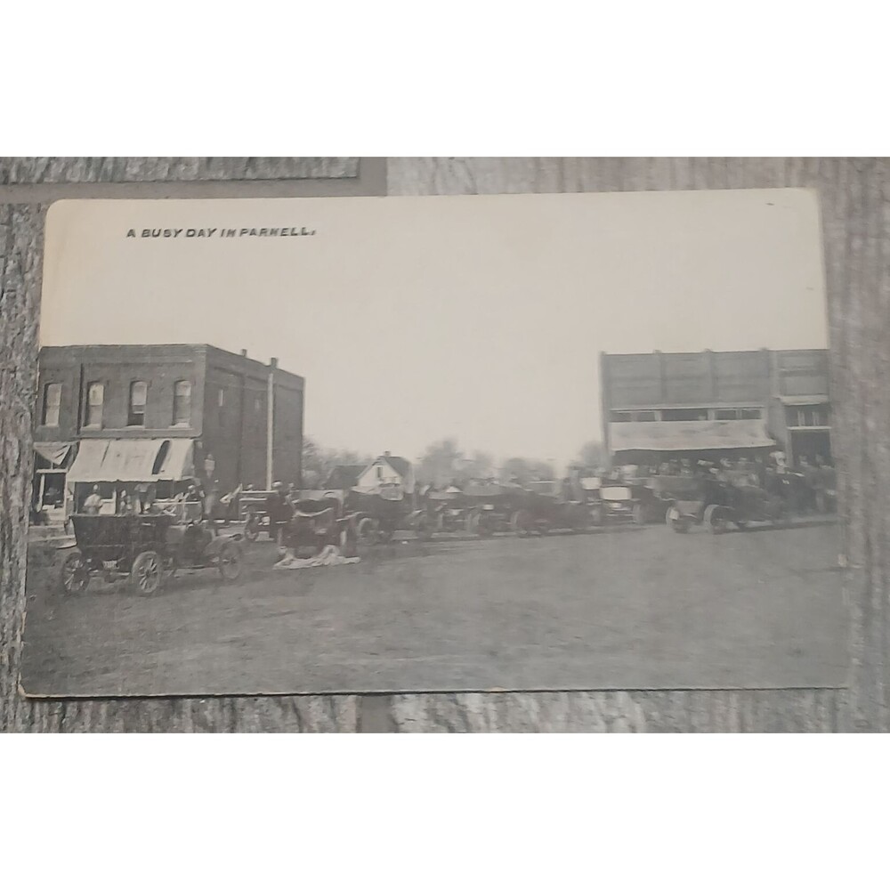 Postcard 1900s Roadsters dirt street downtown  in Parnell Missouri